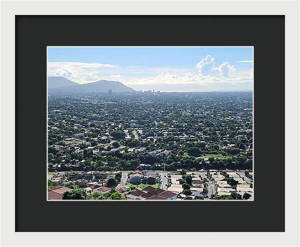 Expansive Cityscape Under Blue Skies - Framed Print